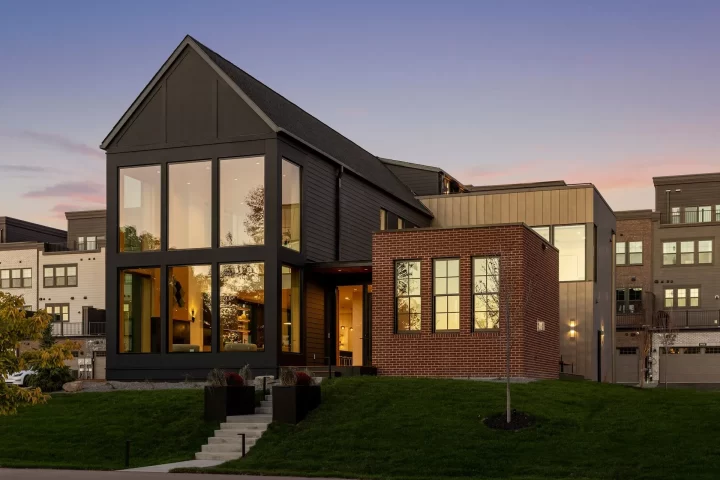 Highland Bridge custom home in the Highland bridge development of St Paul with tall windows, mixed siding, and black exterior